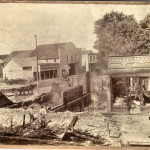 A black and white photo of a building in ruins due to a fire.