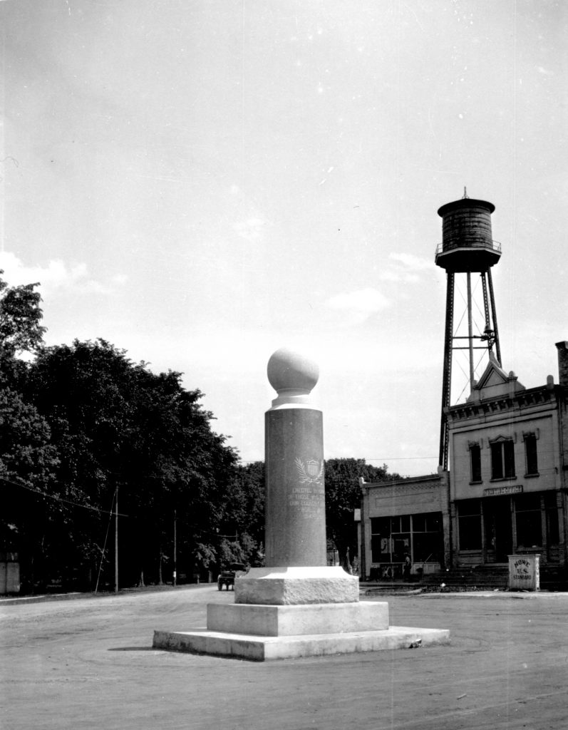 Monument in front of water tower.