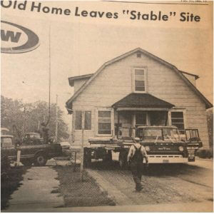 Old house being moved by a truck