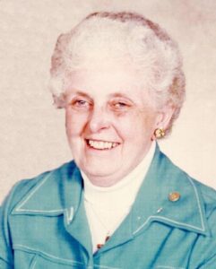 Florice Paulson pictured, woman with white hair in a blue shirt