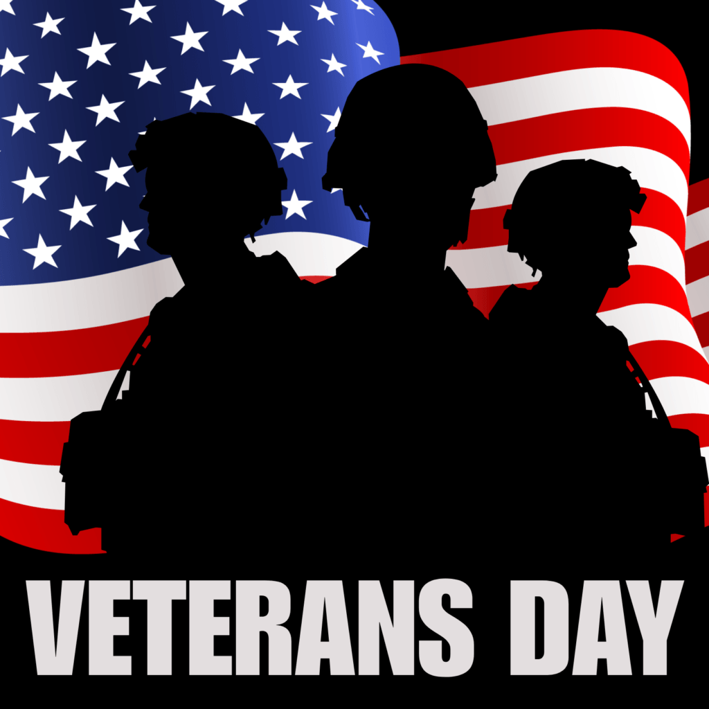 siloette of solders in front of the America flag Veterans Day