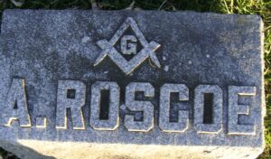 grave marker with the Mason scales around a G and the name A. Roscoe