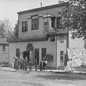 Men standing in front of Cronk Opera House.